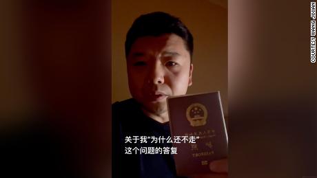 Wang Jixian holding his Chinese passport in a video posted to Douyin, China&#39;s version of TikTok.