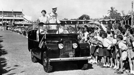 The Queen and Duke of Edinburgh drive past children in Sabina Park, Kingston, during their visit to Jamaica in 1953. 
