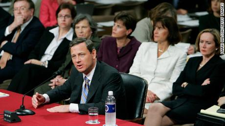 Then-nominee John Roberts answers questions as his wife, Jane Sullivan Roberts (right), watches during his third day of confirmation hearings in September 2005.