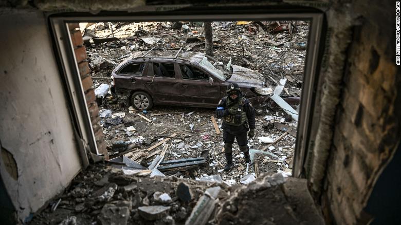 A Ukrainian serviceman stands among debris after shelling in a residential area in Kyiv, Ukraine, on Friday, March 18. 