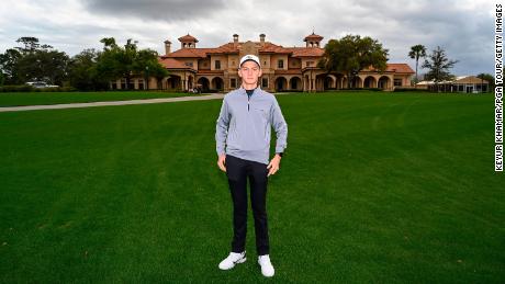 Mykhailo & # 39; Misha & # 39;  Golod stands for a photo in front of the clubhouse at TPC Sawgrass during the final round of the Players Championship.