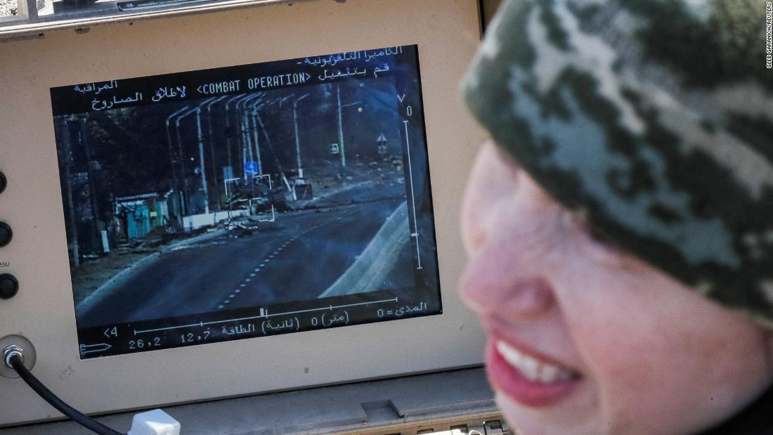 Former Ukrainian Parliament member Tetiana Chornovol, now a service member and operator of an anti-tank guided missile system, examines a Russian tank she destroyed in a recent battle in the Kyiv region.