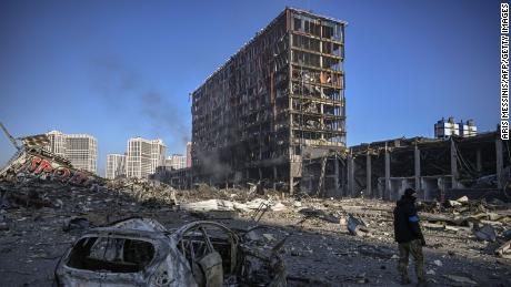 A Ukranian serviceman walks among the rubble of the Retroville shopping mall, Kyiv, on March 21, 2022.  