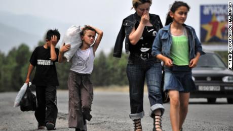 A Georgian family leave the town of Gori on August 12, 2008, following shelling.