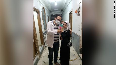 Hamza, wife Waad and daughter Sama al-Kateab in a hospital in Aleppo, Syria. 