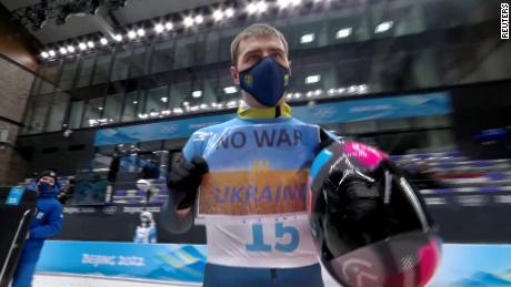 Heraskevych holds a sign with a message reading &#39;No war in Ukraine&#39; during the Beijing 2022 Winter Olympics in February.