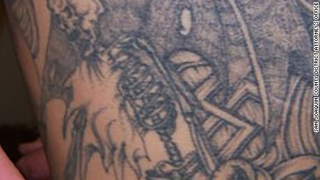 A photo of Jeremy Jones&#39; tattoos revealing a swastika below the wing of a skeleton. 