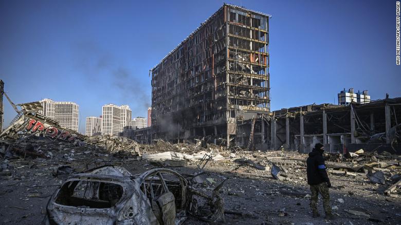 A Ukranian serviceman walks among debris outside the destroyed Retroville shopping mall in in the capital of Kyiv on March 21.