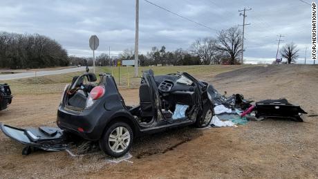 A heavily damaged vehicle is seen off a road in Tishomingo, Oklahoma, following a two-vehicle collision in which six teenage girls were killed on Tuesday, March 22, 2022. 
