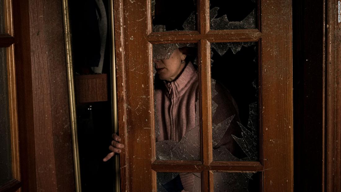 A woman cleans up a room March 21 in a building that was damaged by bombing in Kyiv.