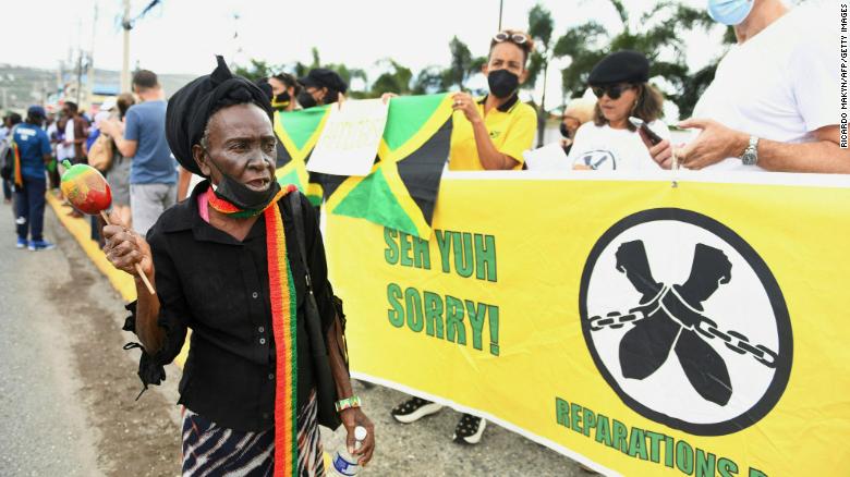 People call for slavery reparations outside the entrance of the British High Commission in Kingston, Jamaica on Tuesday. 