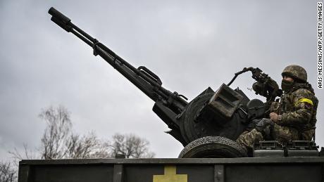 An Ukrainian soldier keeps position sitting on a ZU-23-2 anti-aircraft gun at a frontline northeast of Kyiv on March 3, 2022.
