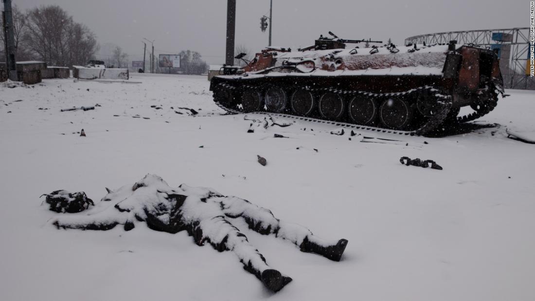 Snow covers the body of a dead Russian soldier near a highway outside Kharkiv, Ukraine, a day after the invasion began. 