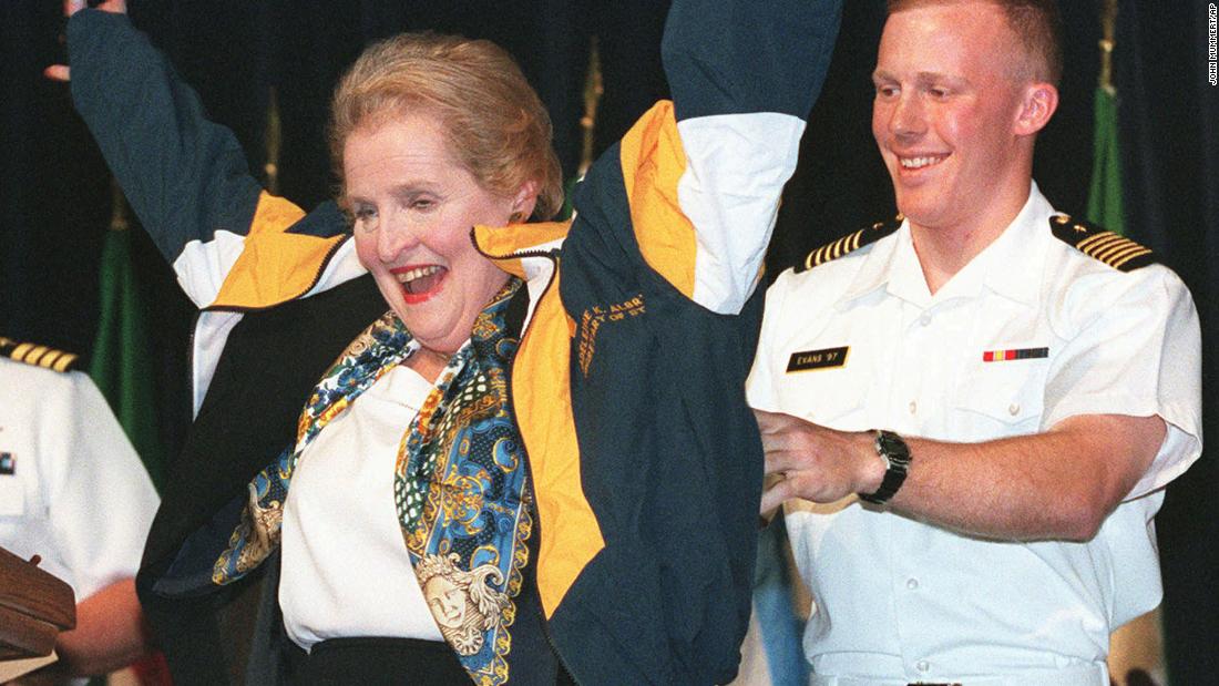Albright puts on a jacket as she visits the US Naval Academy in 1997.