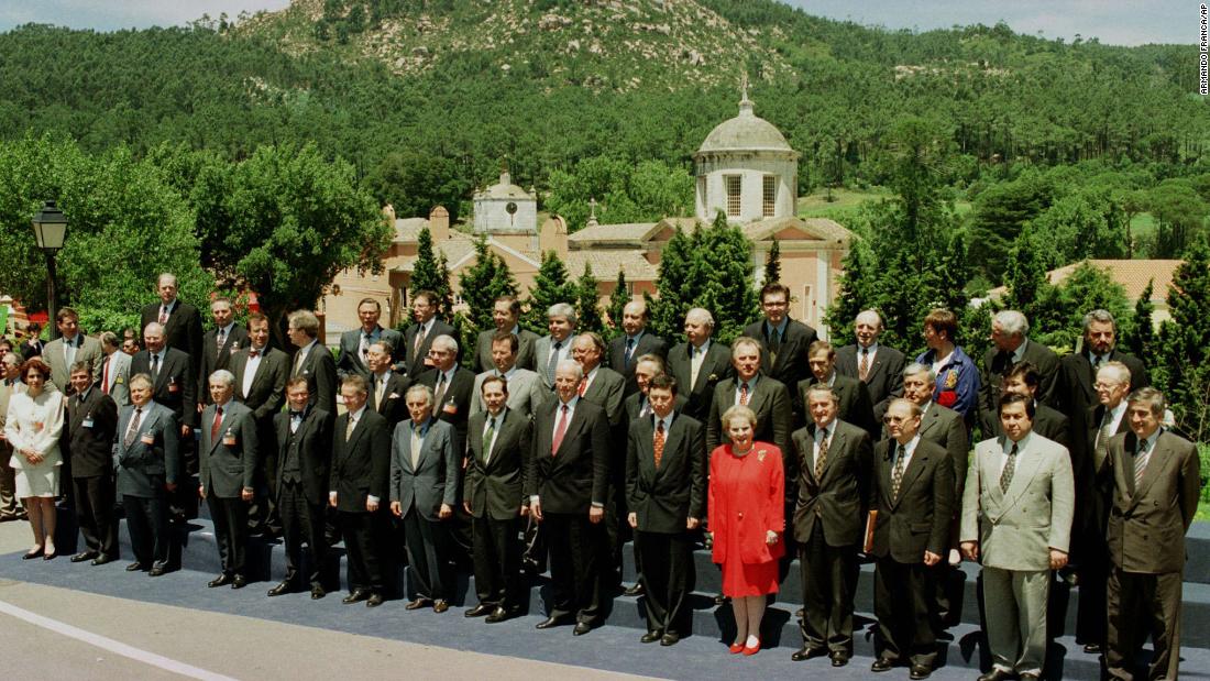 Albright&#39;s red outfit stands out in a sea of suits as she poses with other foreign ministers during a NATO meeting in Lisbon, Portugal, in 1997.