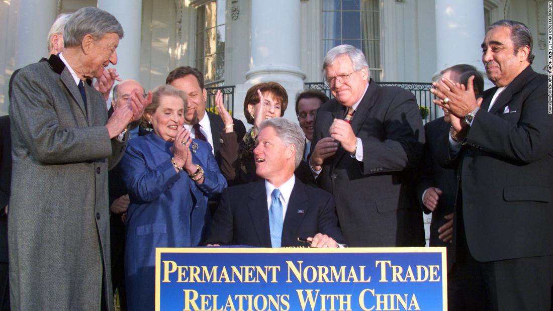 President Bill Clinton is surrounded by Albright and others in 2000 while signing bipartisan legislation normalizing trade relations with China.