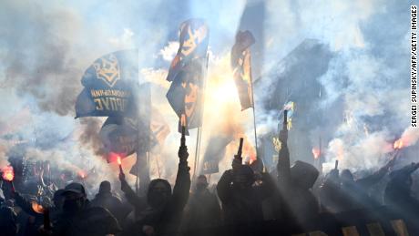 Nationalist activists light flares and shout anti-Russian slogans during a demonstration in front of President Volodymyr Zelensky&#39;s offices in Kyiv on October 14, 2020.
