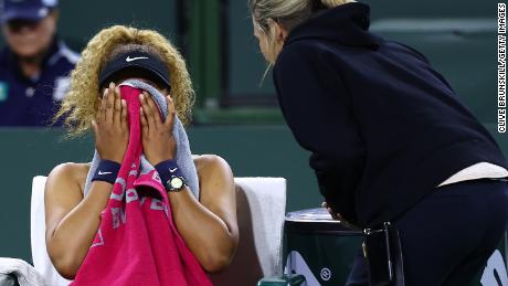 Naomi Osaka is seen speaking with WTA supervisor Clare Wood after play was disrupted by a shout from the crowd during the BNP Paribas Open on March 12, 2022 in Indian Wells, California.