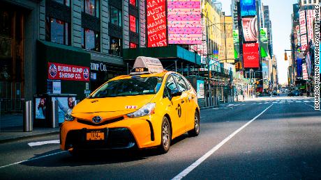 A taxi drives down Times Square on March 26, 2020 in New York City. 