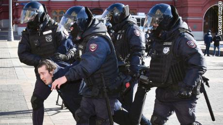 Police officers detain a protest in central Moscow on March 13 - but no opposition to the war is shown on Russian state-run TV.