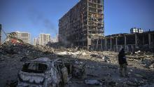 A Ukranian serviceman walks between debris outside the destroyed Retroville shopping mall in a residential district after a Russian attack on the Ukranian capital Kyiv on March 21, 2022. - At least six people were killed in the overnight bombing of a shopping centre in the Ukrainian capital Kyiv, an AFP journalist said, with rescuers combing the wreckage for other victims. (Photo by ARIS MESSINIS / AFP) (Photo by ARIS MESSINIS/AFP via Getty Images)