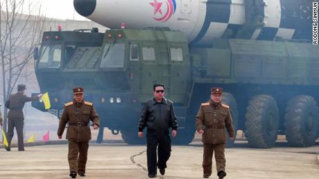 North Korean leader Kim Jong Un walks in front of a rocket, in a photo released by state media on Friday.