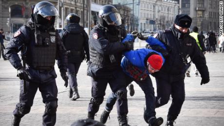 Police officers detain a man during a protest against Russia&#39;s invasion of Ukraine in Moscow on March 13, 2022.