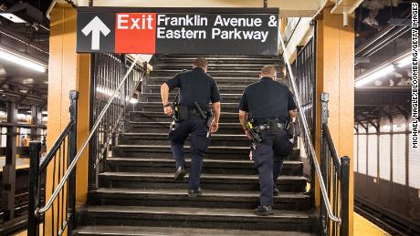 NYPD officers patrol the Franklin Avenue subway station last July in New York, where a crackdown on quality-of-life offenses has renewed debate over &quot;broken windows&quot; policing.