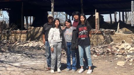 José Hernández, left, stands with his wife and three children in front of their home. The family, who lives in Carbon, Texas, lost everything after the Eastland Complex swept through town.