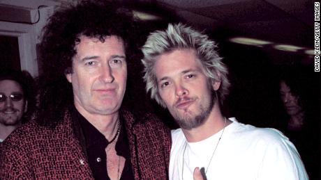 Queen guitarist Brian May poses with Hawkins in January 2002.