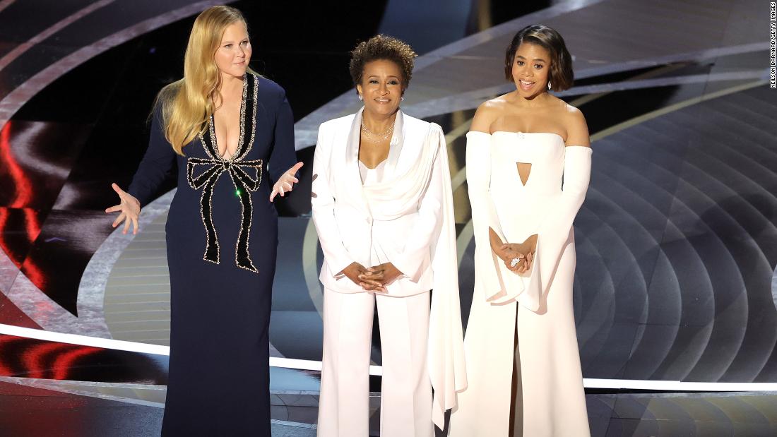 From left, Schumer, Sykes and Hall open the show. &quot;This year the Academy hired three women to host because it&#39;s cheaper than hiring one man,&quot; &lt;a href=&quot;https://www.cnn.com/entertainment/live-news/oscars-2022/h_c82e4b5f103b06fb28939559d21f5b39&quot; target=&quot;_blank&quot;&gt;Schumer joked.&lt;/a&gt;