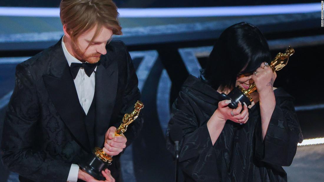 Billie Eilish and her brother, Finneas O&#39;Connell, react after winning the Oscar for best original song (&quot;No Time to Die&quot;).