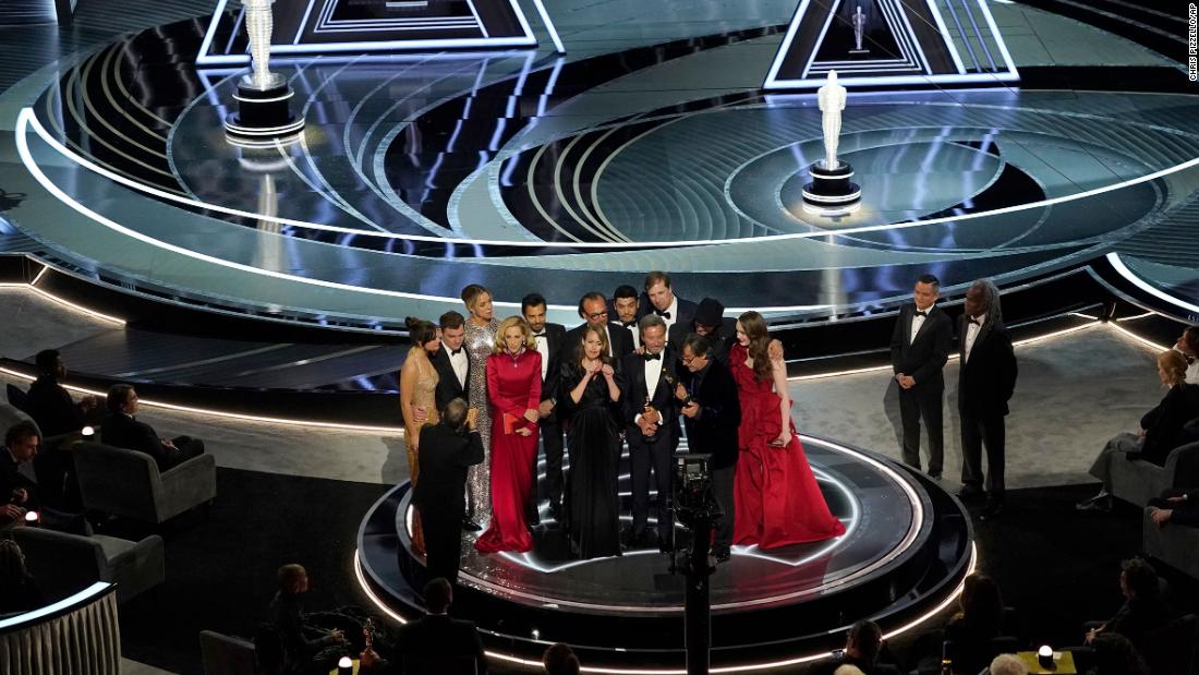 The cast and crew of &quot;CODA&quot; accepts the Oscar for best picture.