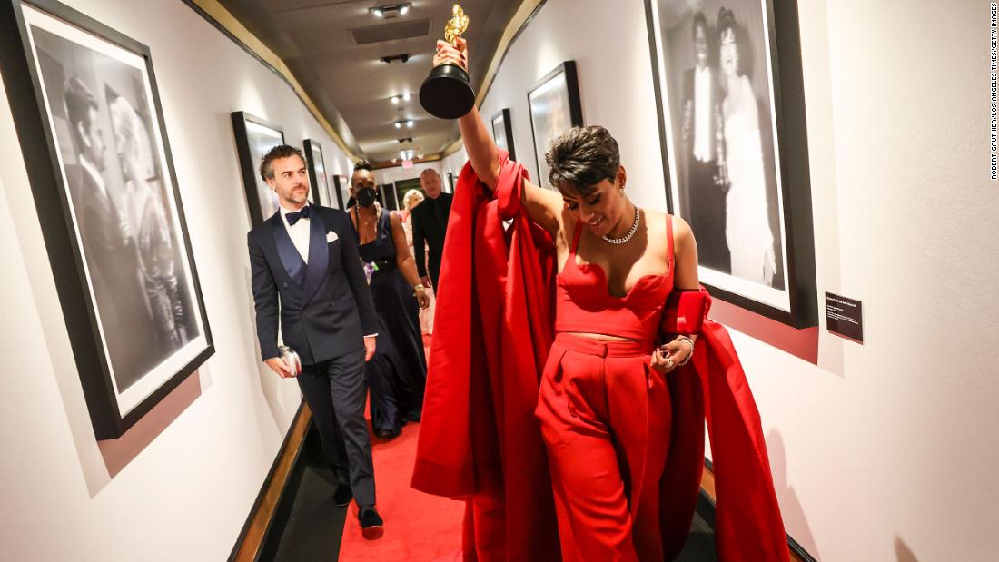 Best supporting actress Ariana DeBose holds her Oscar backstage.