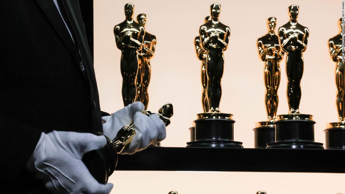 Oscar statuettes sit on display behind the scenes.