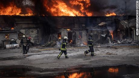 Firefighters work to extinguish a fire at a warehouse after it was hit by Russian shelling on March 28, 2022 in Kharkiv, Ukraine. 