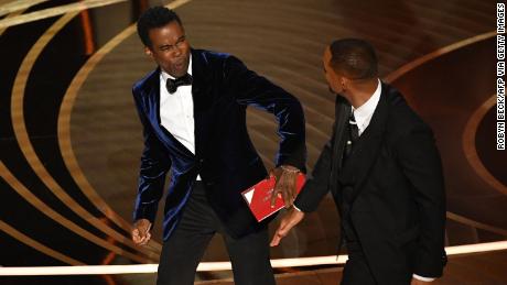 Will Smith (right) punches Chris Rock (left) onstage at the 94th Academy Awards show held at the Dolby Theater in Hollywood, California, on March 27. 