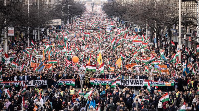 Supporters of Orban&#39;s Fidesz party march in Budapest on March 15. Orban has been adamant that he will not support sanctions that target Russian energy experts. 