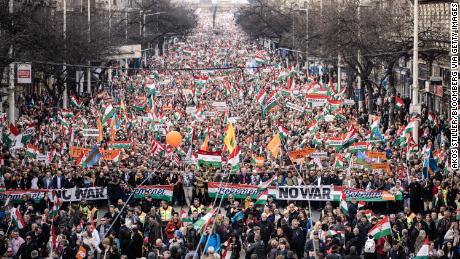 Supporters of Orban&#39;s Fidesz party march in Budapest on March 15. Orban has been adamant that he will not support sanctions that target Russian energy experts. 