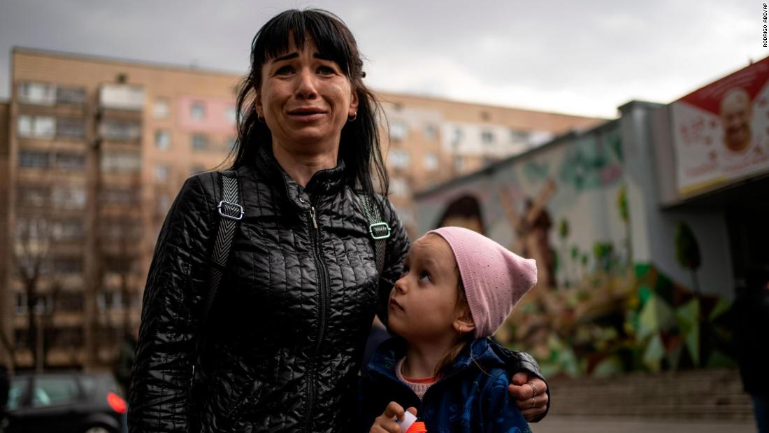 A woman named Julia cries next to her 6-year-old daughter, Veronika, while talking to the press in Brovary, Ukraine, on March 29.