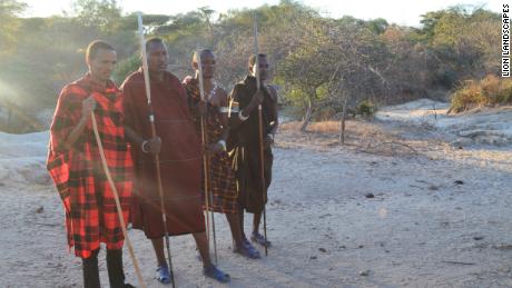 Stephano Asecheka (pictured second from left) is part of a team of "Lion Defenders"  that track lions and work with the community to reduce risk to both human and lion populations.