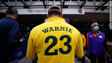 man wearing "  Warnie "  Jersey attends a state memorial service for former Australian cricketer Warren.