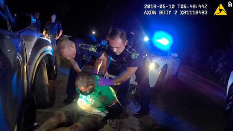 This body camera image of Louisiana State Trooper Dakota DeMoss shows his colleagues, Kory York, center left, and Chris Hollingsworth, center right, holding Ronald Greene before officers arrived. paramedics on May 10, 2019, outside Monroe, Louisiana. 