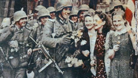A Nazi propaganda image showing German troops being hailed as liberators in Riga, Latvia, during World War II.