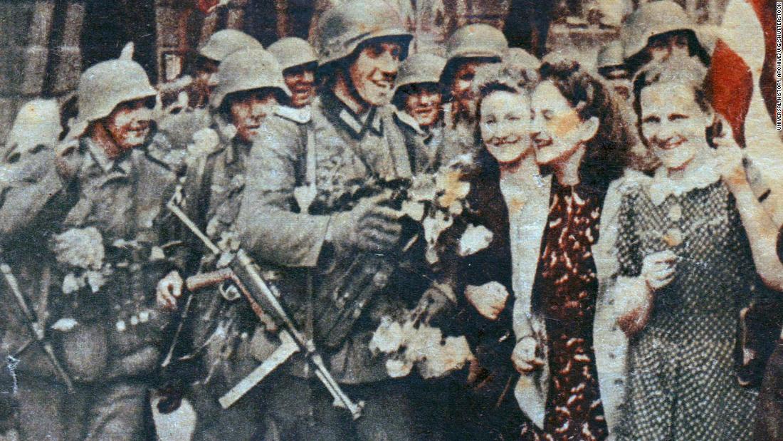 A Nazi propaganda image showing German troops being hailed as liberators in Riga, Latvia, during World War II.