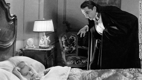 Bela Lugosi creeps up on the sleeping Lucy Weston, played by Frances Dade in &#39;Dracula&#39;, directed by Tod Browning in 1931.