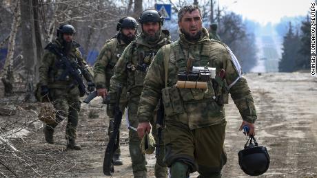 Service members from the Chechen Republic walk during fighting in the Ukraine-Russia conflict in the city of Mariupol on March 31, 2022. 