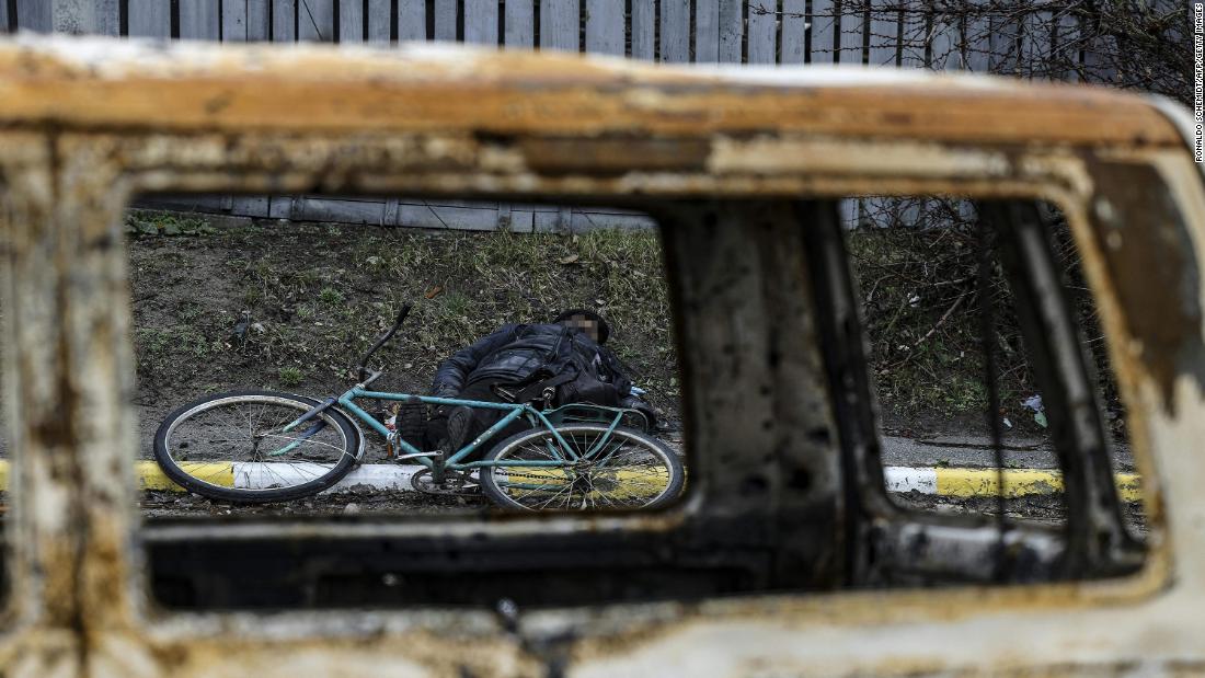 The body of a dead man lies on the ground in a street in Bucha on Saturday. A portion of this photo has been blurred to protect his identity. 