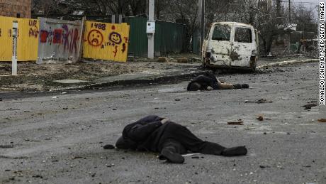 Bodies lie in a street in Bucha on Saturday. A portion of this photo has been blurred to protect the victim&#39;s identity. 