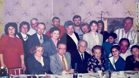 A photo taken about 25 years ago shows Margaryta Zatuchna with her family.  She is pictured in the fourth row from the left in the second row, wearing glasses and a pink blouse.  To her right is her late husband Valerii.